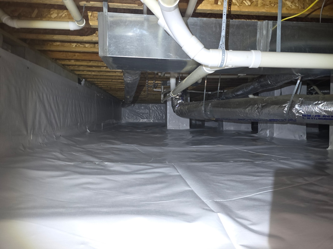 Crawl space with moisture barrier and HVAC ducts visible in a clean, well-maintained environment.