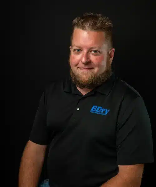 Man in black polo shirt with BDRY logo against a dark background.